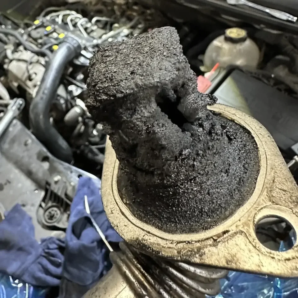 EGR turbo repair - a dirty pipe from the EGR shows how soot-stained engine components can be